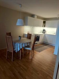 a kitchen with a table and chairs in a room at Aida 7 Guest Apartement in Pärnu