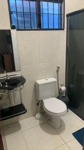 a bathroom with a toilet and a sink at Privê estrela in Porto De Galinhas