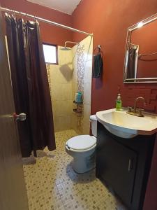 a bathroom with a toilet and a sink and a shower at Amplio y familiar in Cabo San Lucas