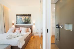 מיטה או מיטות בחדר ב-Unìco Boutique Hotel d'Arte