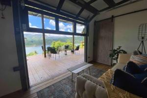 a living room with a large glass door and a patio at Villa Exclusiva para parejas en Puerto Rico in Villalba