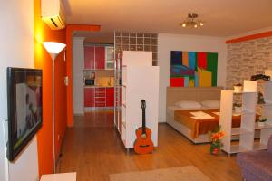 a room with a bed and a guitar in it at The City Residence Hotel in Çanakkale