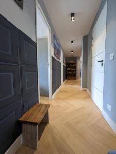a hallway with a wooden bench and a room with cabinets at Lovely Refurbished Apartment in Nice