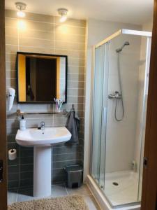 a bathroom with a sink and a shower with a glass door at Apartment Panoramica Golf in Sant Jordi