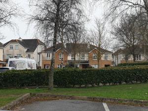 a group of houses and a van parked in a yard at Kilkenny City Apartment in Kilkenny