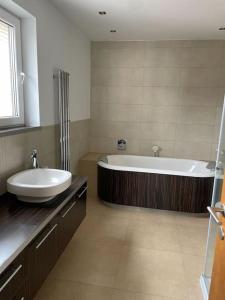uma grande casa de banho com banheira e lavatório em Apartmán Dominika Bojnice em Bojnice