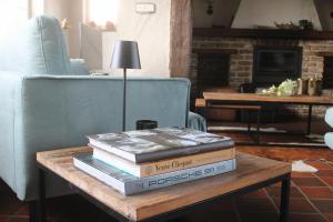 a stack of books sitting on a coffee table at Maison Margareta in Middelburg