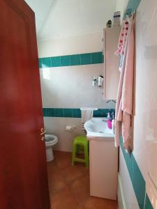 a bathroom with a sink and a toilet at Il Nido in Olbia +10 photos