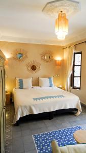 a bedroom with a large bed with two mirrors on the wall at Monriad in Marrakech