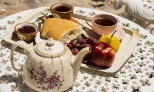 a tray of food with a tea kettle and fruit at Cielo Arriba Casa in Humahuaca +12 photos