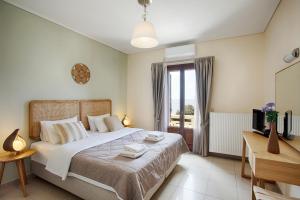 a bedroom with a large bed and a window at Aithra -Agios Petros Andros in Gavrio
