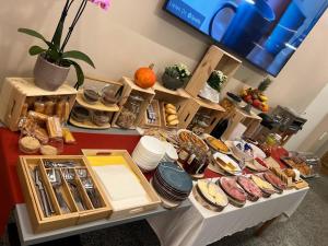 a table filled with lots of different types of food at Regina Bed & Breakfast in Agno