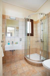 a bathroom with a shower and a sink at Aithra -Agios Petros Andros in Gavrio +37 photos