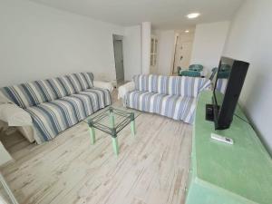 a living room with a couch and a tv in it at Luxury apartment in Zahara beach in Zahara de los Atunes