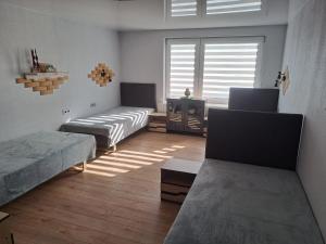 a living room with two beds and a window at Stay at Svaja in Plungė