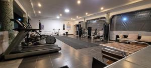 a gym with a treadmill and a living room at Different in Bagamoyo