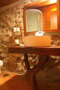 a bathroom with a counter with a sink and a mirror at Casa Da Rocha in Caldelas