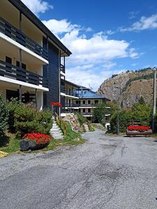 an empty street in front of a building at La petite maison in La Thuile