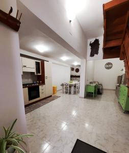 a living room with a kitchen and a dining room at Casa vacanze Galena in Iglesias +15 photos