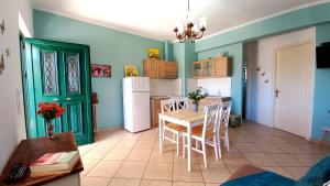 a kitchen with a table and chairs and a refrigerator at AGIOS LEON Apartment 3 in Agios Leon