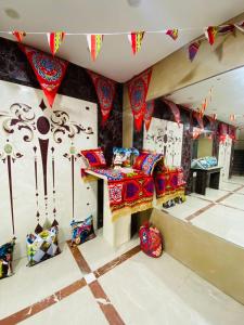 a room with a bed and colorful decorations at Zafero Studios and Apartments - Families only in Alexandria