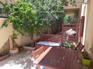 a wooden table and chairs sitting on a patio at Appartamento a 50 mt dal mare in Cala Gonone