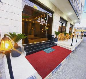 a building with a red carpet in front of a store at Anbat Midtown Hotel in Wadi Musa