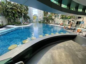 ein großer Pool in der Mitte eines Gebäudes in der Unterkunft Stylish Condo with pool, sauna, steam room & gym in Pattaya