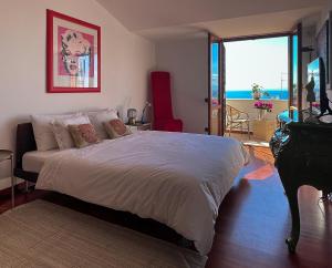 a bedroom with a bed with a view of the ocean at Donna Rachele in Aci Castello