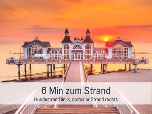 a pier on the beach at sunset with the words min zim stand at Hunde ohne Aufpreis - Fewo Hagemeister Sellin - auch im Winter toll! Sauna im Haus - 6 Min zum Strand - 2 überdachte Balkone mit Strandkörben in Ostseebad Sellin
