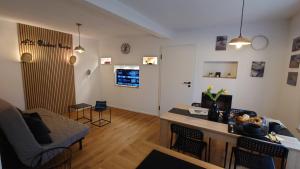 a living room with a couch and a table with chairs at alte Bäckerei Bautzen - 04 #Business# in Bautzen