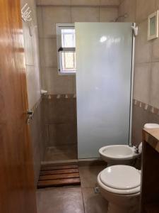 a small bathroom with a toilet and a shower at Bendito Alcázar Cabañas in Colón +35 photos