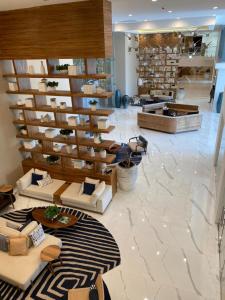 a lobby with couches and tables in a store at Camino al Mar 802 Vista al Mar in Mazatlán