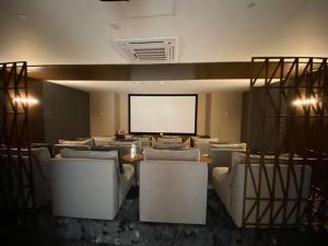 a conference room with white chairs and a white screen at Camino al Mar 802 Vista al Mar in Mazatlán +42 photos