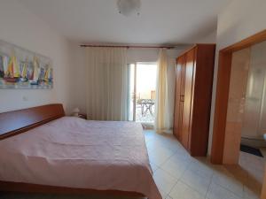 a bedroom with a large bed and a window at Olive garden Pag studio apartment in Pag