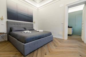 Un pat sau paturi într-o cameră la Residenze Florio