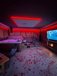 a room with blood on the floor and a tv at Jacuzzi Home in Oradea