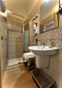 a bathroom with a sink and a shower at La corte di Angelica in Sciacca