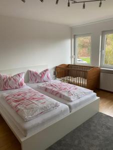 a bedroom with two beds and two windows at Ferienhof Kröger in Bielefeld +258 photos