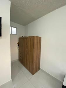 a room with a wooden cabinet in the corner at Apartamento en Cartagena in Cartagena de Indias