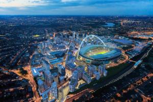 an aerial view of a city with a stadium at Charming 6-Bed Apartment in Wembley Area in London