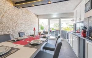 a dining room with a table and chairs and a kitchen at Stunning Home In Klimno With Outdoor Swimming Pool in Klimno