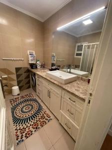 a bathroom with a sink and a mirror at Apartment for rent in Ramo 6 October in 6th Of October