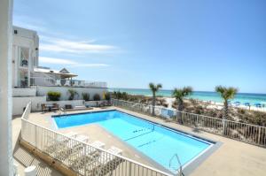 a swimming pool with the ocean in the background at Starfish Villa in Panama City Beach