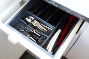 a drawer with scissors and other utensils in it at Grójecka Apartament in Warsaw