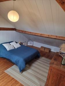a bedroom with a blue bed in a tent at Quai 2 voie C 
