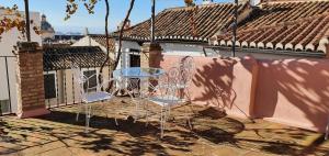 a table and chairs sitting on a balcony at Casa Cuesta del Perro in Granada