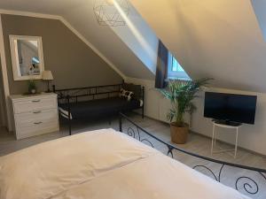 a bedroom with a bed and a tv in a attic at Hotel-Gasthof Grüner Hof in Freising