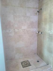 a bathroom with a shower with a tiled shower at Steps to the Beach l Private Apt Stay l Parking WiFi Nightlife in San Juan