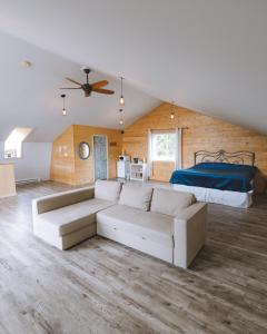 a living room with a couch and a bed at By the Bay Lavender Villa in Chemainus